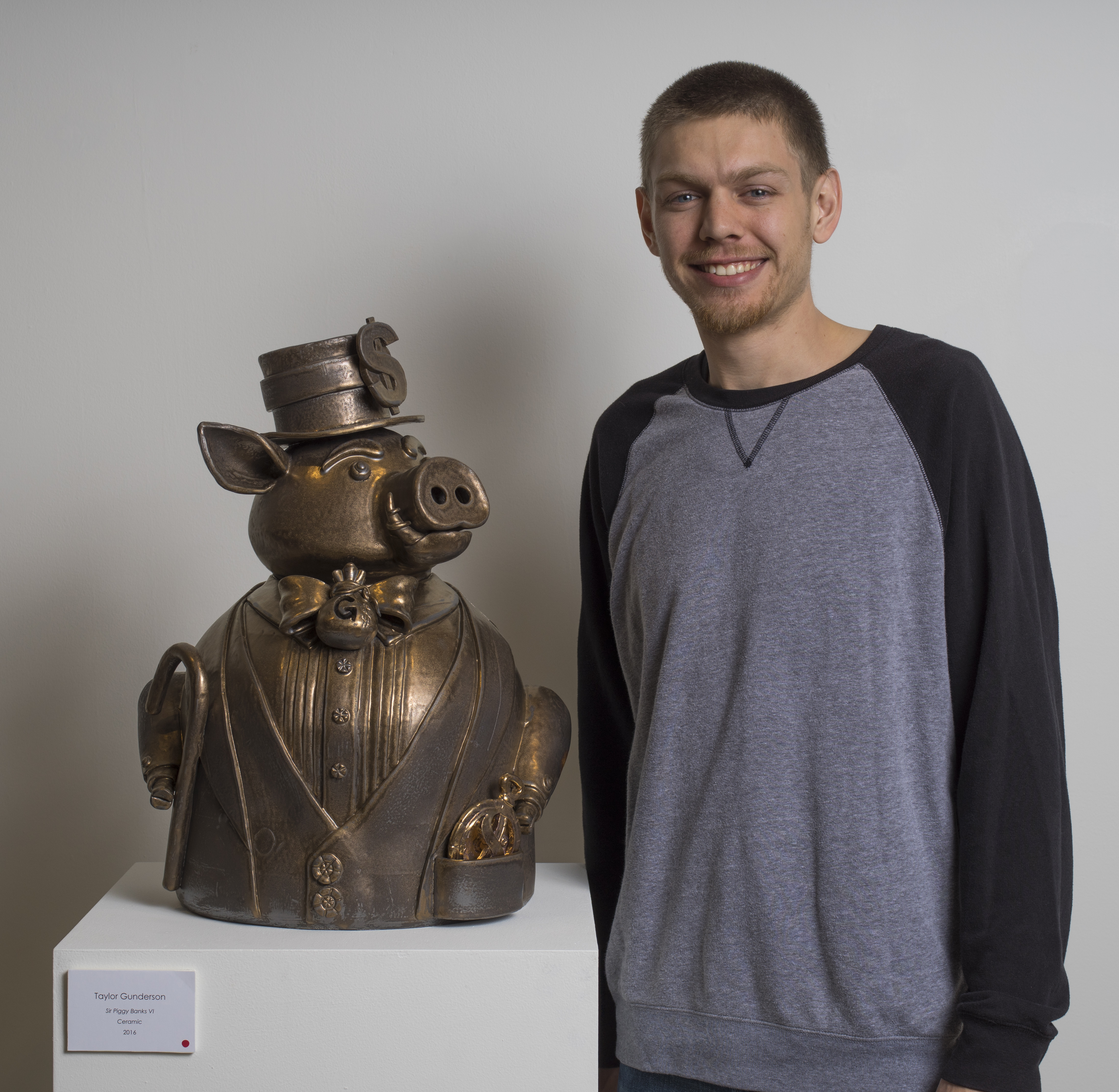 Taylor Gunderson pictured beside his piece, Sir Piggy Banks VI