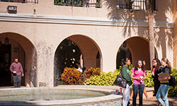 Students walking by the fountain in the Horseshoe on the Gulfport campus