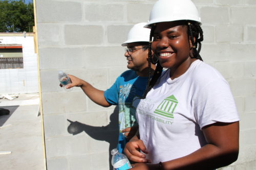 (L-R): Second-year law students Danny Jacobo and Taofikat Ninalowo volunteer for Habitat for Humanity.