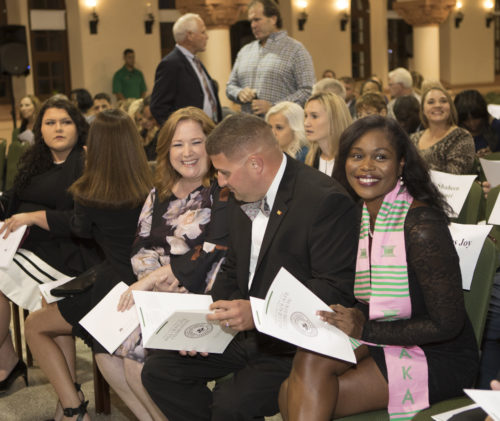 December J.D. candidate Peaches Joy Brown, far right, smiles at Stetson's Fall Graduate Celebration in Gulfport.