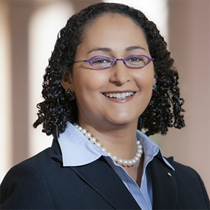 A close-up headshot of Professor Ciara Torres-Spelliscy smiling