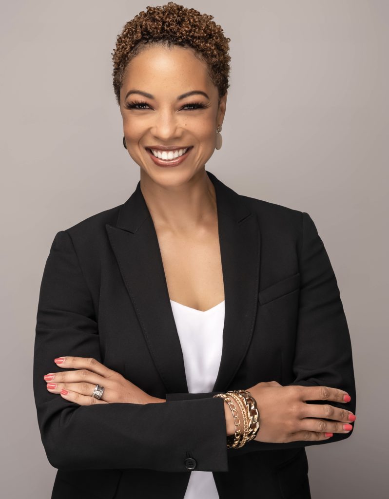 A headshot of Stetson Law alumna Rena Upshaw Frazier wears a suit and smiles at the camera