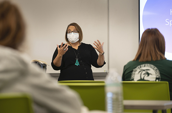 Professor Kirsten Davis gestures during a lecture to a class
