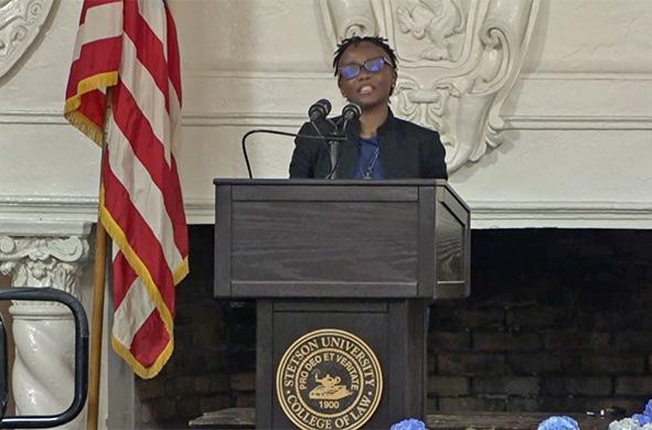 Stetson University College of Law Dean Michèle Alexandre addresses the audience from a podium in the Great Hall