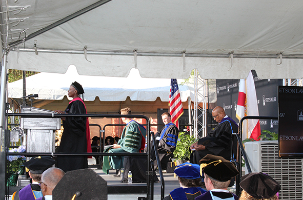 A side angle of Dean Michele Alexandre giving a commencement speech