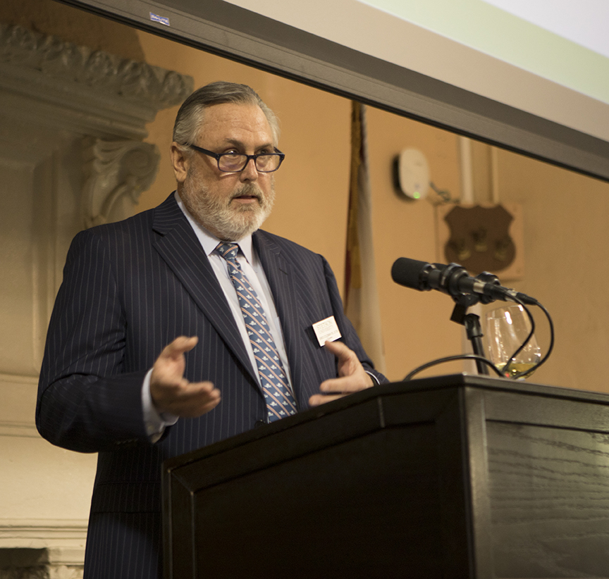 Stetson Law Board of Overseers Chair Greg Coleman speaks at a podium in the Great Hall.