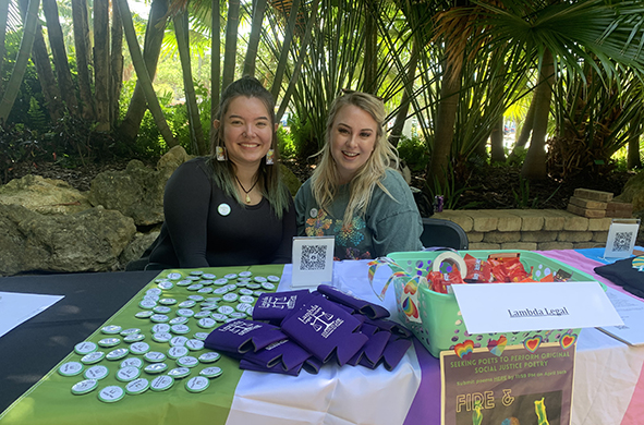 Two people site at a table featuring memorabilia in Stetson Law's Banyan Courtyard