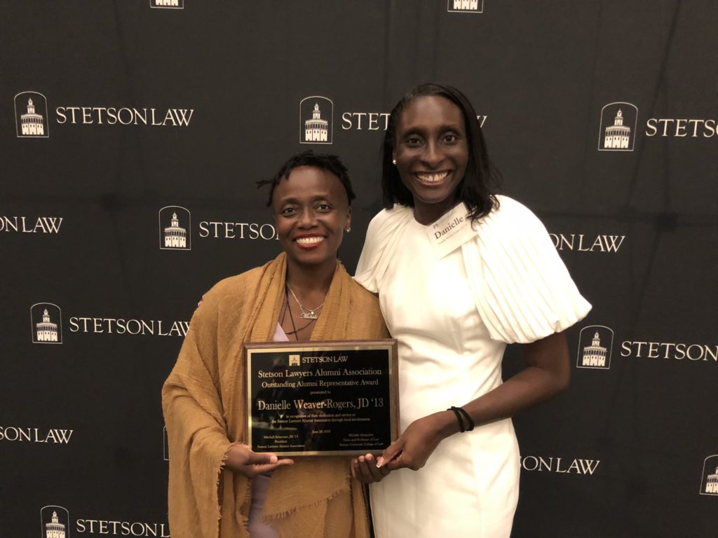 Dean Michele Alexandre and Danielle Wever-Rogers pose with a plaque awarded to Wever-Rogers.