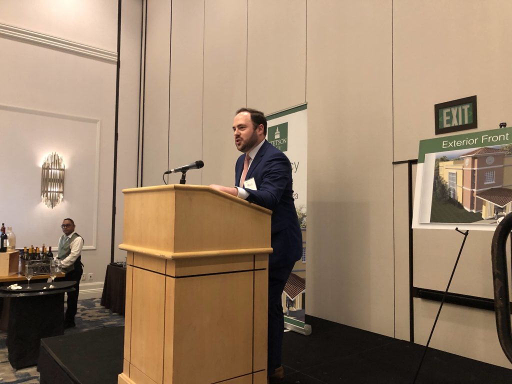 Stetson Lawyers Alumni Association President Mitchell Schermer stands at a podium during the  2022SLAA awards ceremony.