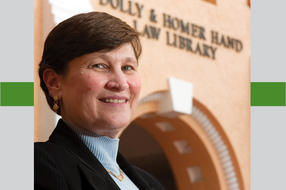 Law Professor Ellen Podgor smiles in front of the library.