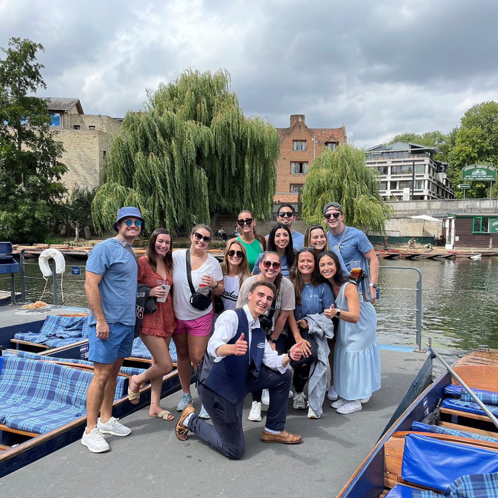 Students gathered on a river dock for a photo in Oxford, England.