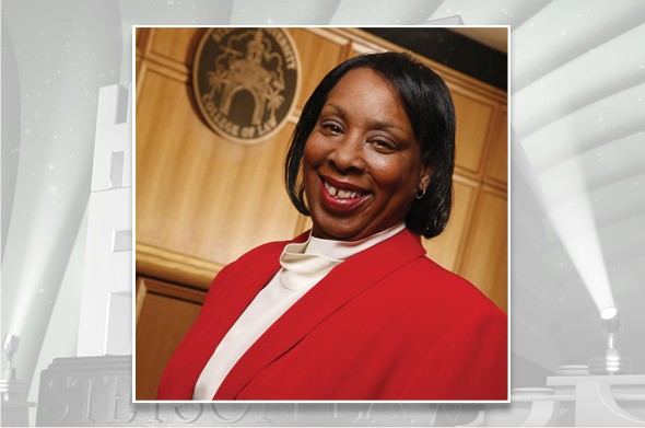 A headshot of Professor Emerita Dorothea A. Beane, who is wearing a red blazer and smiling into the camera.