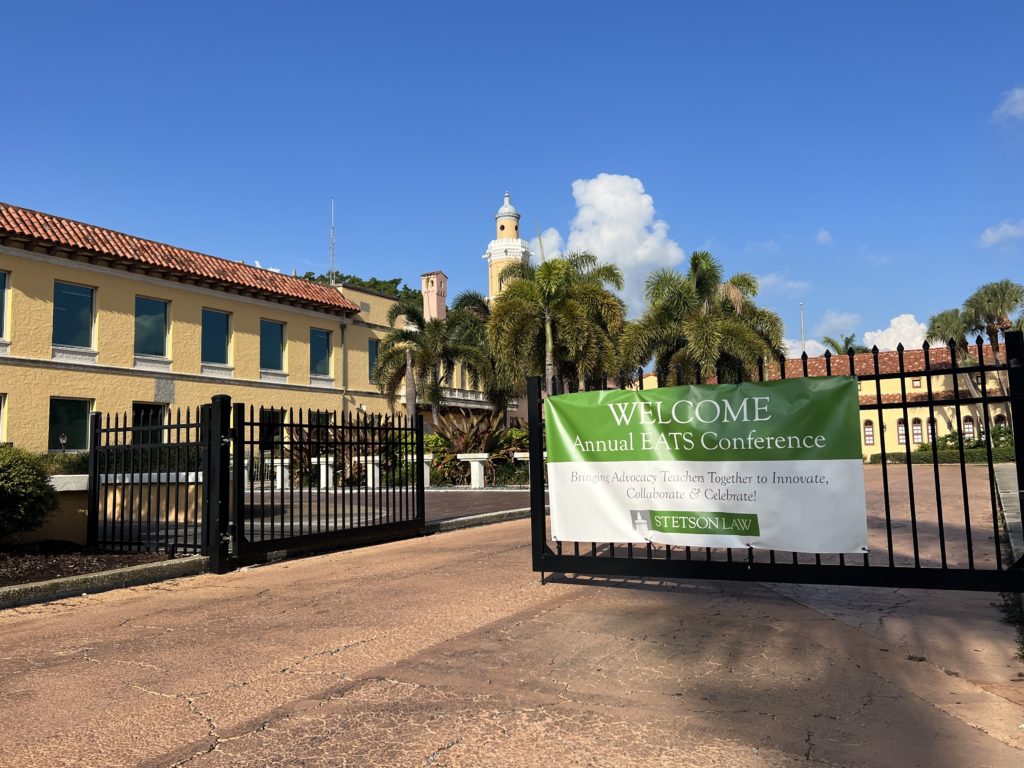 A banner on a gate on the Stetson Law campus says "Welcome Annual EATS Conference."