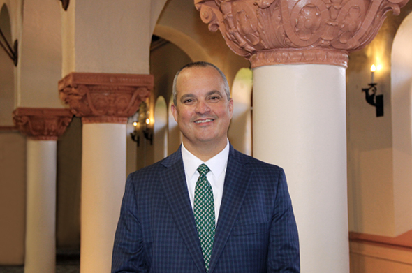 A head shot of Stetson Law Dean D. Benjamin Barros in front of pillars in the Great Hall.