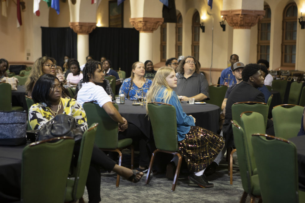 Students and parents watch an event in the Great Hall.