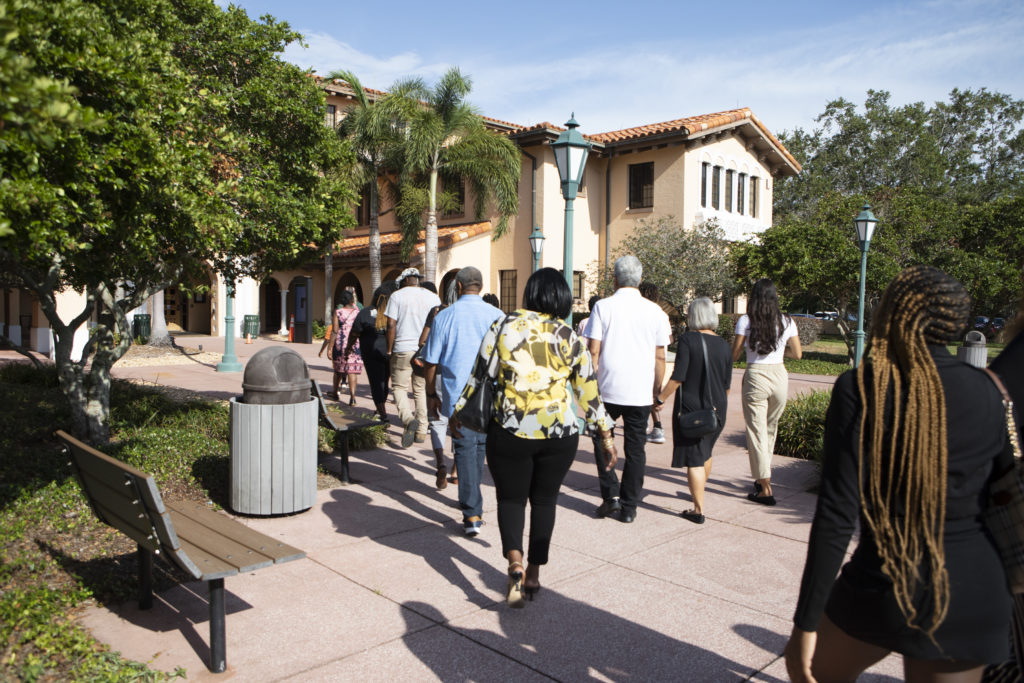 A group of students and parents tours the grounds of Stetson Law.