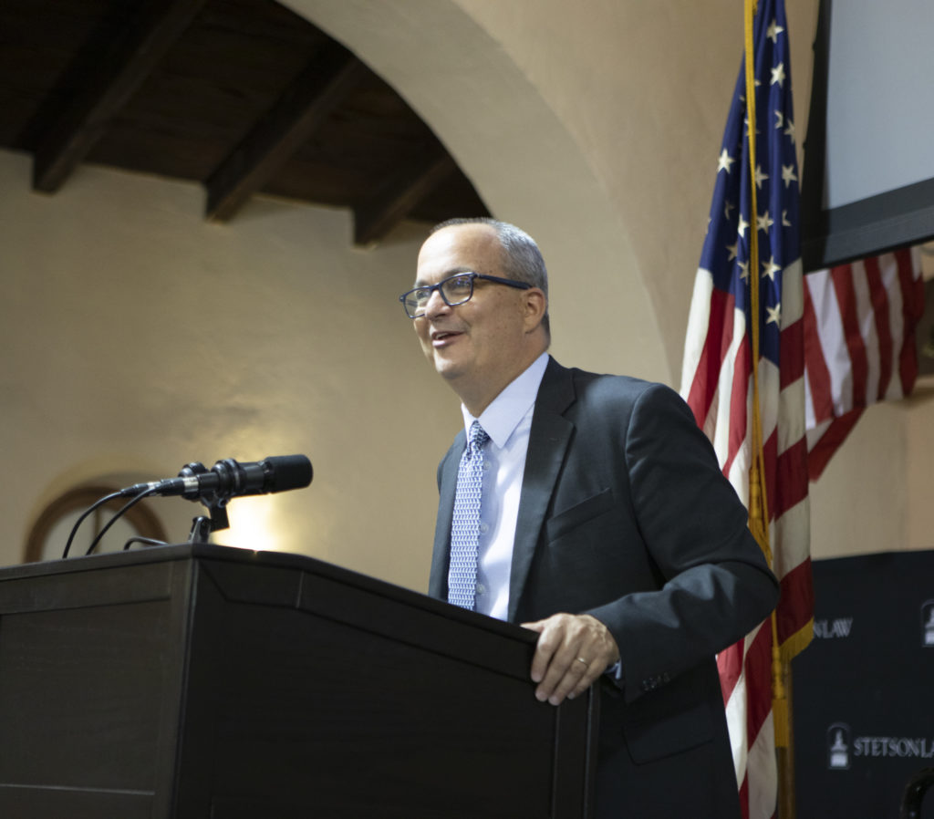 Dean Benjamin Barros speaks at a podium in the Great Hall.