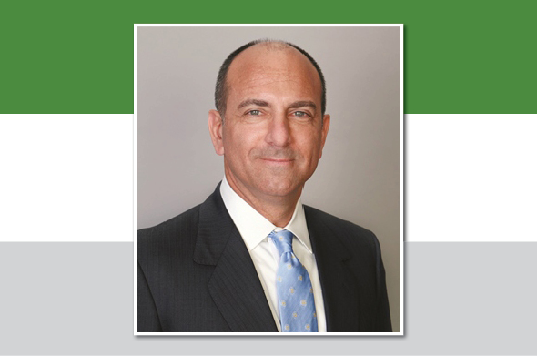 A headshot of a Stetson Law alumnus against a backdrop of Stetson's signature colors, green and gray.
