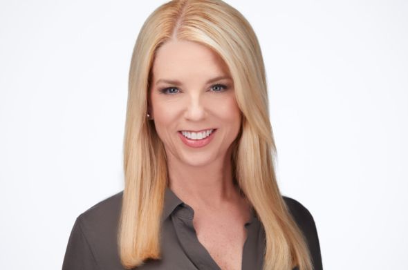 A headshot of a blonde woman smiling