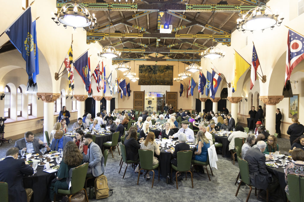 Stetson Law's Great Hall is packed with banquet attendees seated at tables throughout the room.