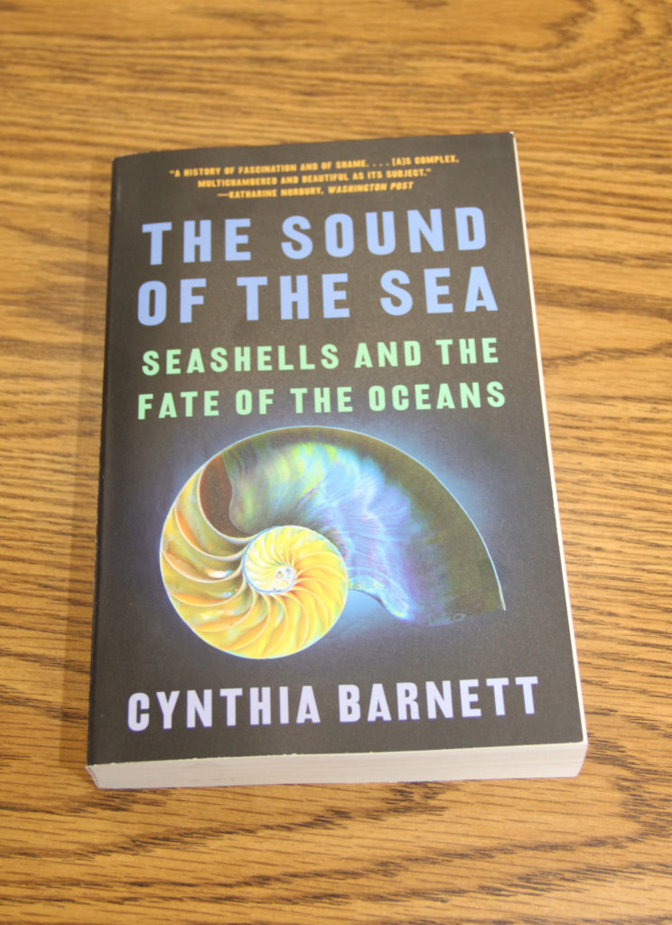 A picture of the front cover of a book titled "The Sound of the Sea: Seashells and the Fate of the Oceans."