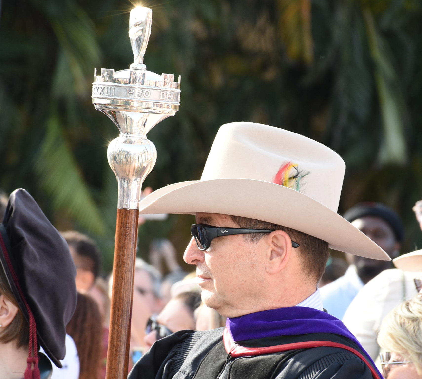 Wearing a Stetson hat, Professor Royal Gardner leads a long line of graduates.