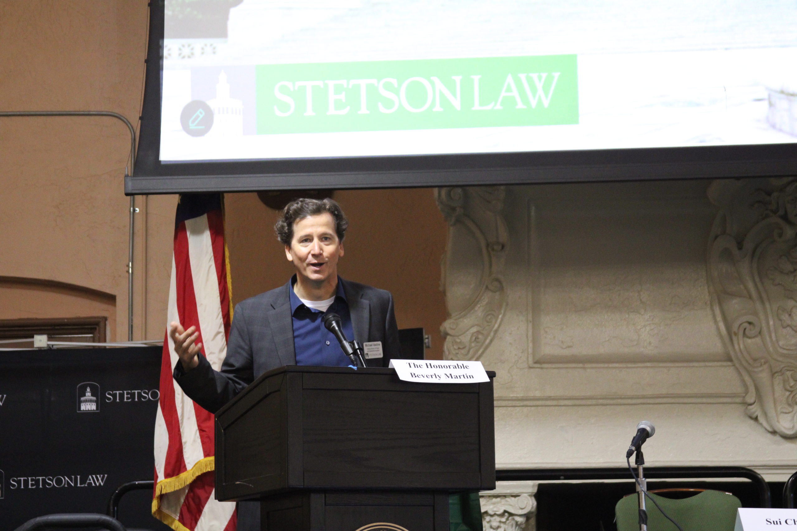 A man stands at the podium in Stetson's Great Hall