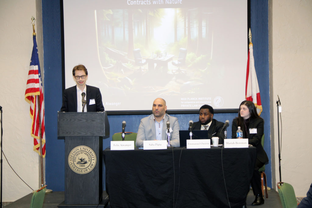 A panel discussion with four wildlife experts who sit at the front of a meeting room.