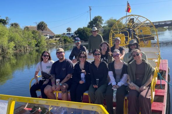 A group of students rides on an airboat in South Florida
