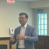 A man speaks in a classroom.