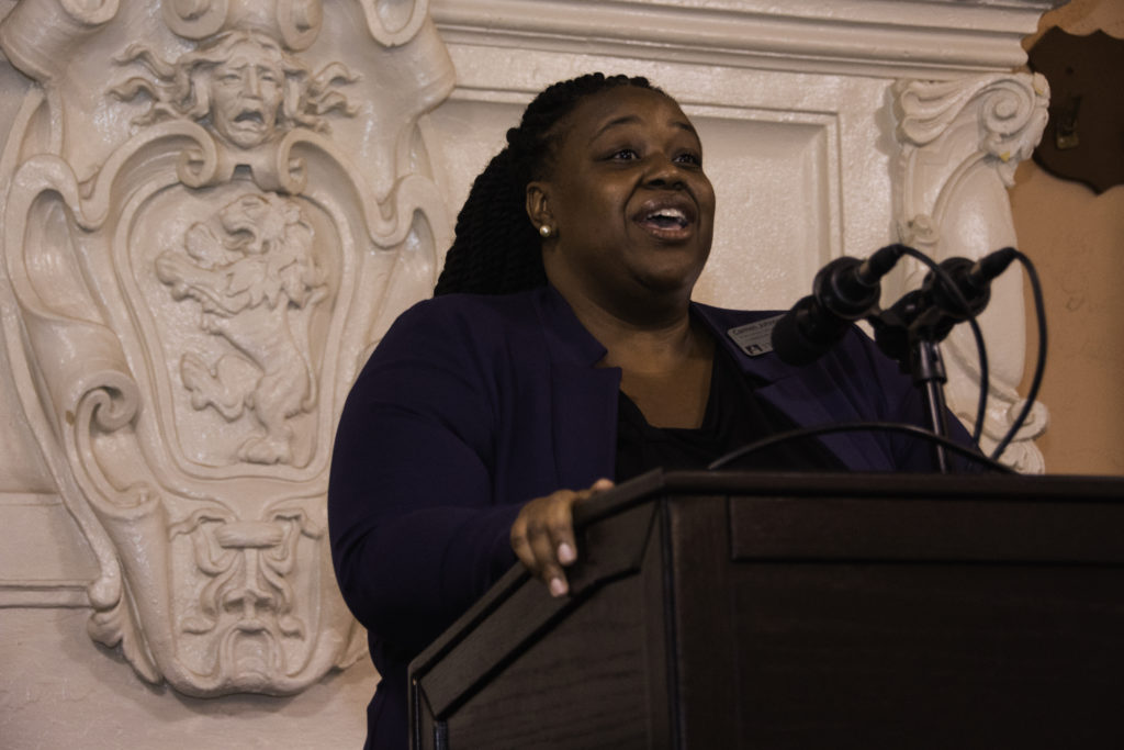 Carmen Johnson speaks at a podium.