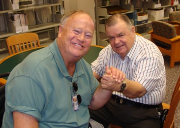 Max Cleland and T. Wayne Bailey shake hands.