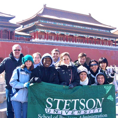 Gary Oliphant, left, with students in Beijing, China’s Tiananmen Square in 2012. Rebecca Oliphant is pictured wearing sunglasses, third from right. 