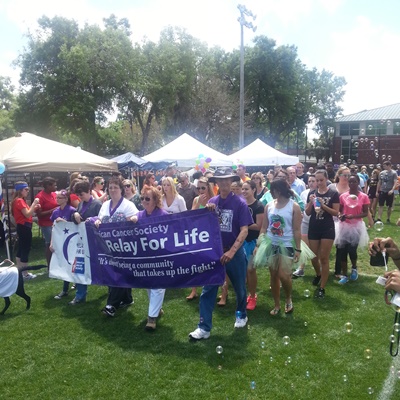 Don Musser, religious studies professor and cancer survivor, (in purple shirt, far right) helps carry the banner for Stetson's Relay for Life.