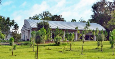 Scenic shot of sloping land and vegetation behind environmental learning center.