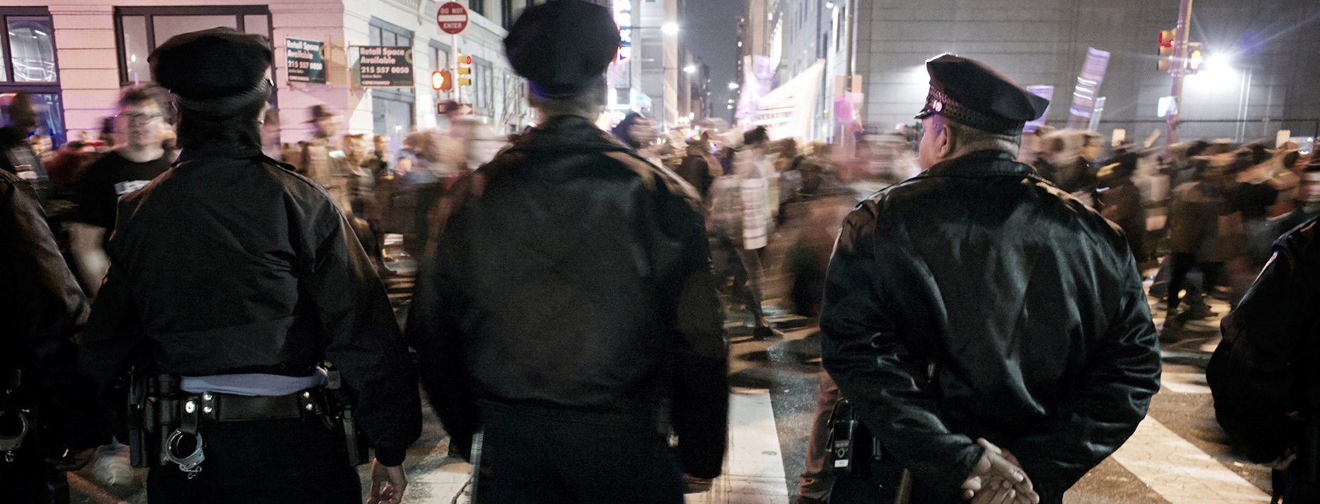 Philadelphia Police Department officers block a road as group protesting Ferguson, Mo., shooting pass by. (photo by Bas Slabbers)