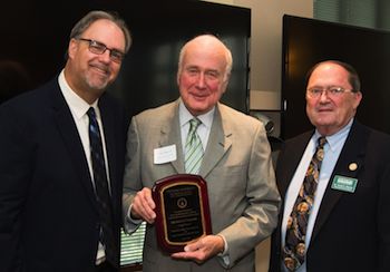 Michael Bitter (left) and Vincent Brenner (right) present Paul Dascher his plaque into the Accounting Hall of Fame.