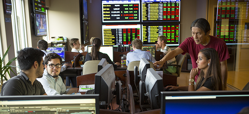 K.C. Ma, Ph.D., C.F.A., assists a student in the Roland George Trading Room on the third floor of the School of Business Administration. Students in the Roland George Investments Program make buy and sell decisions for the $3.5 million portfolio.