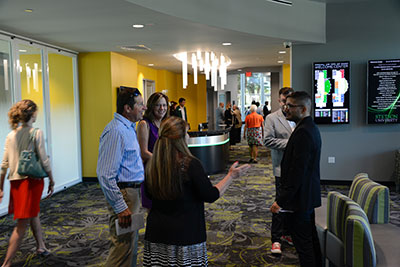 Visitors mingle in the lobby of the new Rinker Welcome Center on Saturday.