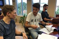 Thomas Kaufmann, a Stetson senior from Brazil, talks with fellow senior Evan Albert, a finance major from Orlando, in the Roland George Trading Room on Friday, Oct. 21. 