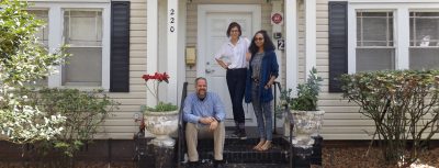 Larry R. Correll-Hughes, Executive Director of Housing and Residential Life, checks in with students Lex Rasdal, center, and Alissa Pagano at the Sustaining Green Living house, one of four Community Catalyst Houses on the Stetson campus.