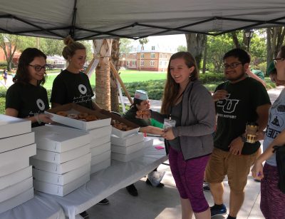Students hand out doughnuts at Friday Student Employee Appreciation Day