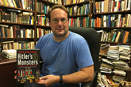 History Professor Eric Kurlander holds his book in his office.