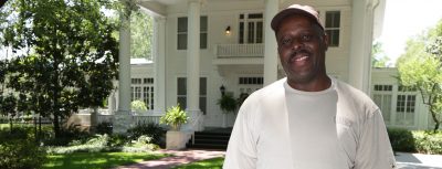 Melvin Young stands in front of President's Home