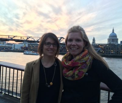 Paige Berges and Allison Foster stand along the river in London.