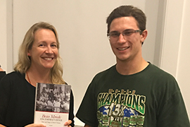 Mayhill Fowler holds book and stands beside student Robert Matyskiel II