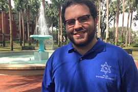 Stetson student Noah Katz stands in Palm Court and the fountain on DeLand campus.