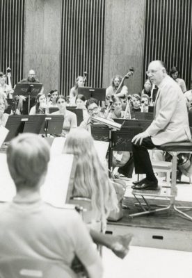 Geoffrey Gilbert sits in a practice room as student musicians during a rehearsal at Stetson.