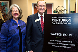 President Wendy Libby and Bill Watson, founder of Watson Realty, stand beside a sign for Stetson's new Centurion Sales Program.