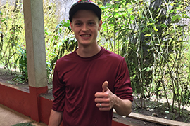 Nathan Bodger gives a thumbs up on a screened-in patio